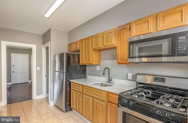 4352 Sheldon Ave, Baltimore, MD 21206 - kitchen with stainless steel appliances, light countertops, and light tile patterned flooring