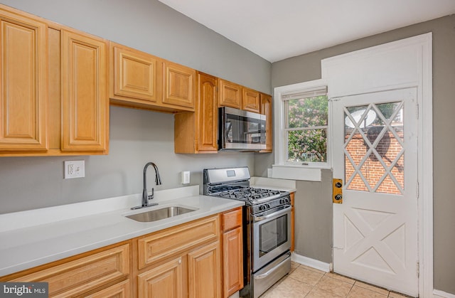 4352 Sheldon Ave, Baltimore, MD 21206 - kitchen with appliances with stainless steel finishes, light countertops, and light tile patterned floors