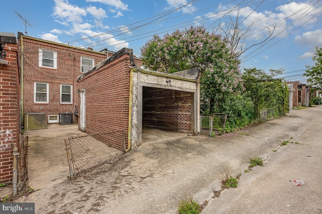 4352 Sheldon Ave, Baltimore, MD 21206 - view of side of home with an attached garage, brick siding, and concrete driveway