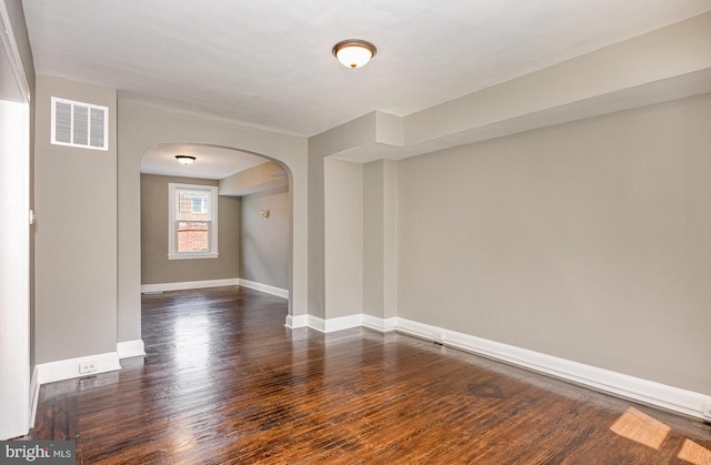 4352 Sheldon Ave, Baltimore, MD 21206 - empty room with arched walkways and dark wood-type flooring