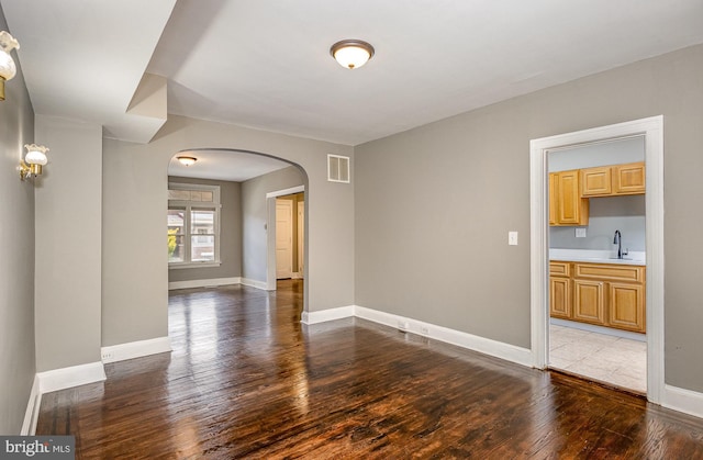 4352 Sheldon Ave, Baltimore, MD 21206 - spare room with arched walkways and hardwood / wood-style floors