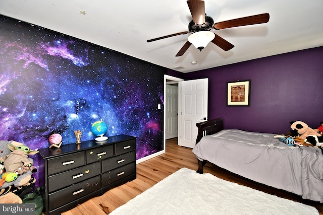 1437 Hilltop Rd, Pottstown, PA 19464 - bedroom with an accent wall, wood finished floors, wallpapered walls, and a ceiling fan