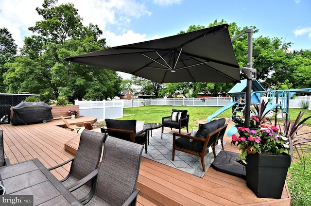 1437 Hilltop Rd, Pottstown, PA 19464 - wooden deck featuring a fenced backyard, an outdoor hangout area, grilling area, and a playground