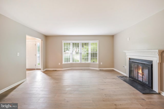 7 Somerset Ct, Annapolis, MD 21403 - unfurnished living room featuring a glass covered fireplace and light wood-style flooring