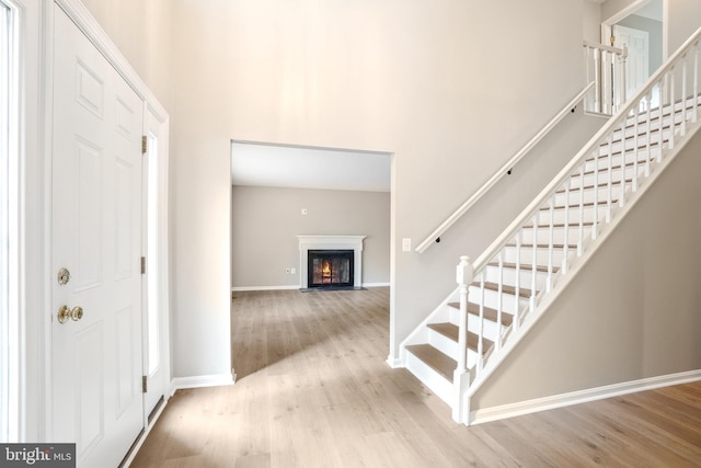 7 Somerset Ct, Annapolis, MD 21403 - entrance foyer with a high ceiling, wood finished floors, stairs, and a fireplace with flush hearth