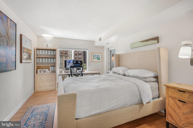 2121 Jamieson Ave Unit 707, Alexandria, VA 22314 - bedroom with wood finished floors and a textured ceiling