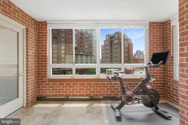 2121 Jamieson Ave Unit 707, Alexandria, VA 22314 - exercise area with a city view, brick wall, and stone finish flooring