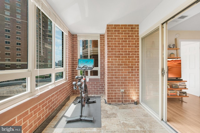 2121 Jamieson Ave Unit 707, Alexandria, VA 22314 - exercise room featuring brick wall
