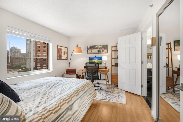 2121 Jamieson Ave Unit 707, Alexandria, VA 22314 - bedroom featuring light wood finished floors and a desk