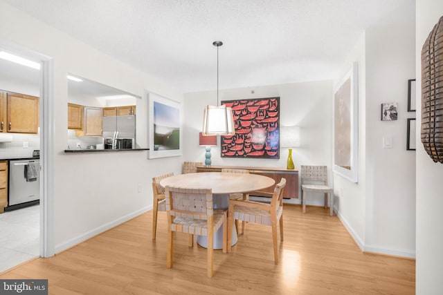 2121 Jamieson Ave Unit 707, Alexandria, VA 22314 - dining space with light wood-style floors and baseboards