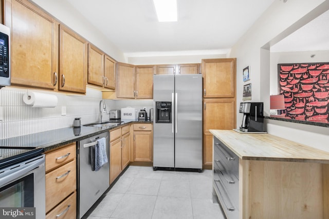 2121 Jamieson Ave Unit 707, Alexandria, VA 22314 - kitchen featuring appliances with stainless steel finishes, light tile patterned floors, and butcher block countertops