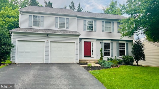 4085 Brittany Dr, Ellicott City, MD 21043 - view of front of home with driveway, a garage, and a front lawn