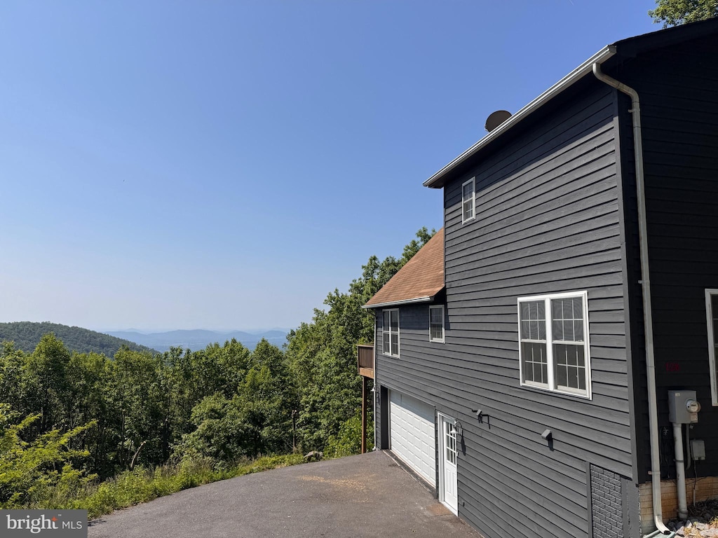 728 Shenandoah Valley Dr, Front Royal, VA 22630 - view of home's exterior featuring an attached garage, driveway, and a forest view