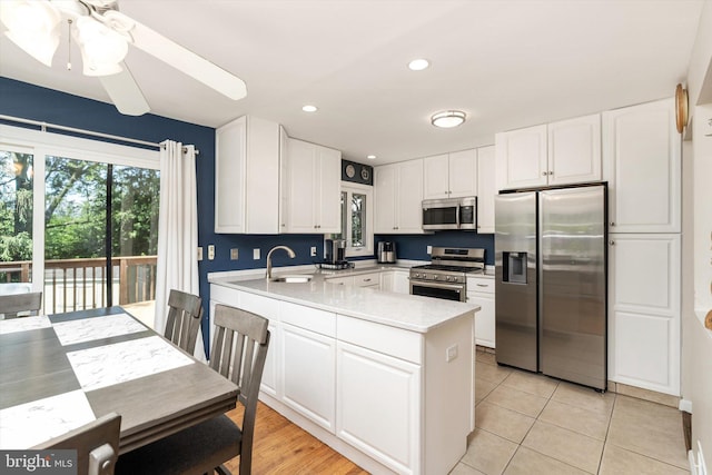 5 Wisteria Ln, Hamilton, NJ 08690 - kitchen featuring appliances with stainless steel finishes, a peninsula, light countertops, white cabinetry, and recessed lighting