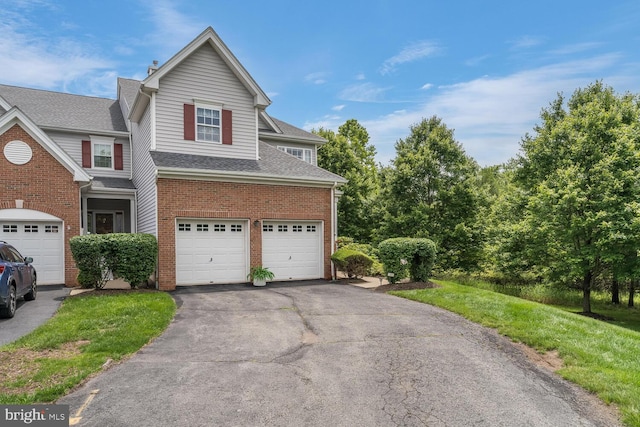 17 Paddock Ln, Flemington, NJ 08822 - traditional home with driveway, an attached garage, brick siding, and a shingled roof