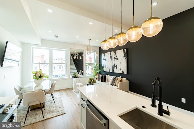 2517 Ontario Rd NW Unit Ph7, Washington, DC 20009 - kitchen with stainless steel dishwasher, light wood-type flooring, pendant lighting, open floor plan, and recessed lighting