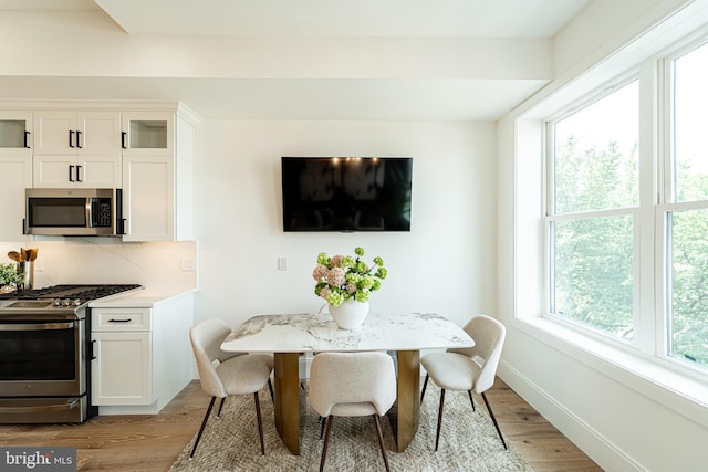 2517 Ontario Rd NW Unit Ph7, Washington, DC 20009 - dining area featuring light wood-style flooring and baseboards