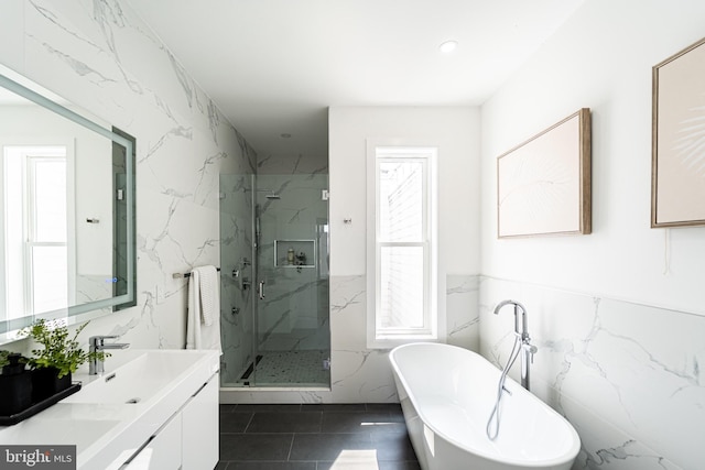 2517 Ontario Rd NW Unit Ph7, Washington, DC 20009 - full bath with tile walls, a marble finish shower, a freestanding tub, double vanity, and tile patterned floors