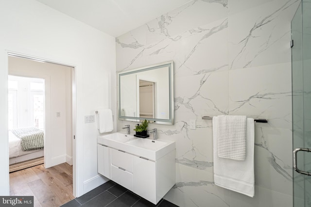 2517 Ontario Rd NW Unit Ph7, Washington, DC 20009 - ensuite bathroom featuring double vanity, a marble finish shower, and wood finished floors