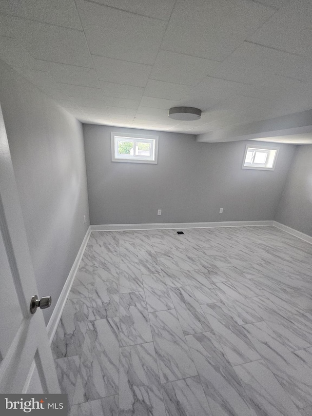 1608 Howard, Baltimore, MD 21221 - basement featuring marble finish flooring, healthy amount of natural light, and a drop ceiling