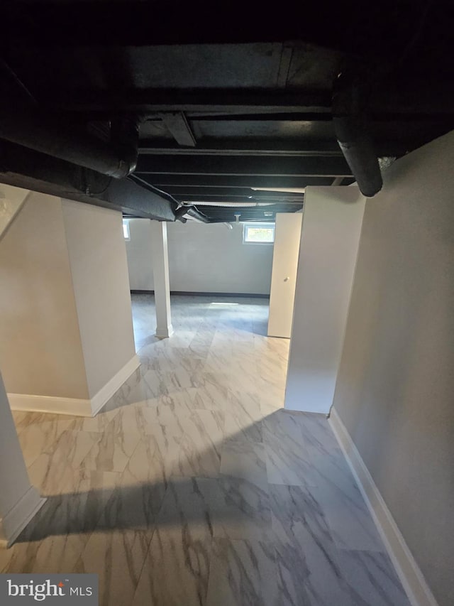 1608 Howard, Baltimore, MD 21221 - basement featuring marble look tiles and baseboards