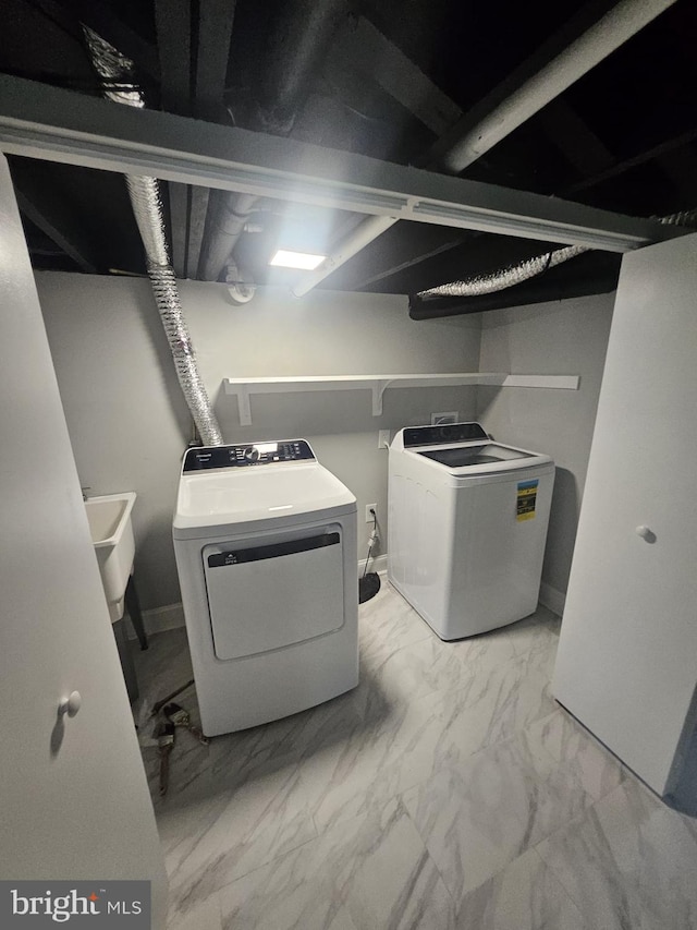 1608 Howard, Baltimore, MD 21221 - laundry area featuring independent washer and dryer and marble look tiles