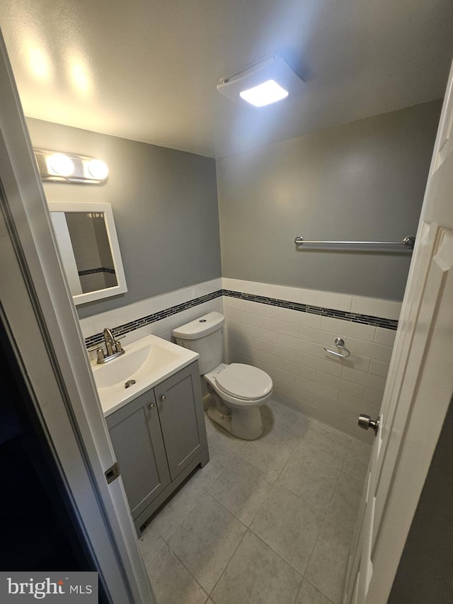 1608 Howard, Baltimore, MD 21221 - half bath featuring tile walls, tile patterned flooring, a wainscoted wall, and vanity