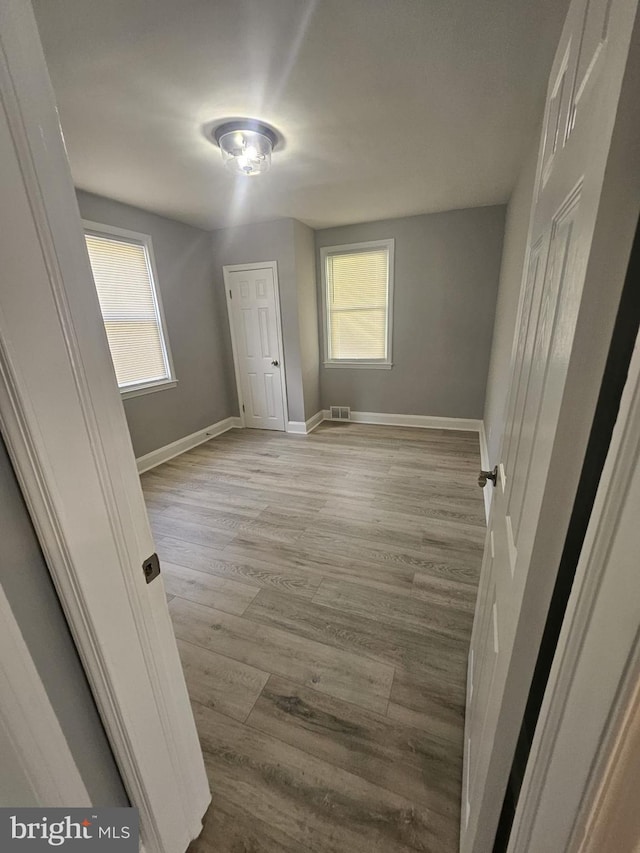 1608 Howard, Baltimore, MD 21221 - spare room featuring plenty of natural light and light wood-style flooring