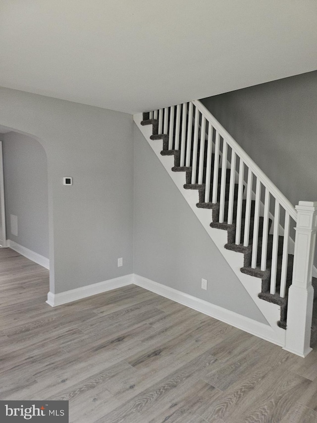 1608 Howard, Baltimore, MD 21221 - stairway featuring wood finished floors and arched walkways