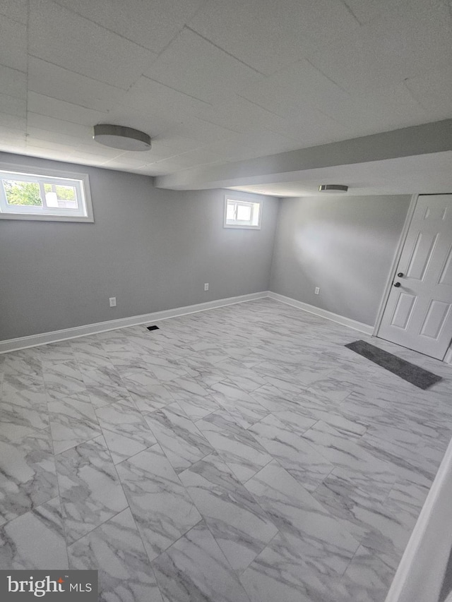 1608 Howard, Baltimore, MD 21221 - below grade area featuring marble finish flooring and baseboards