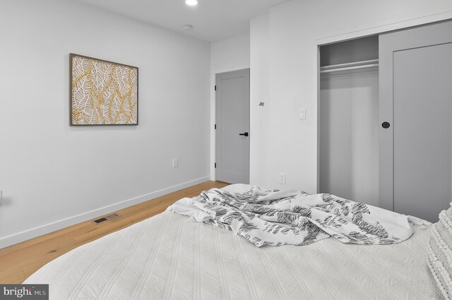 3306 E Lombard St, Baltimore, MD 21224 - bedroom with a closet, wood finished floors, and recessed lighting