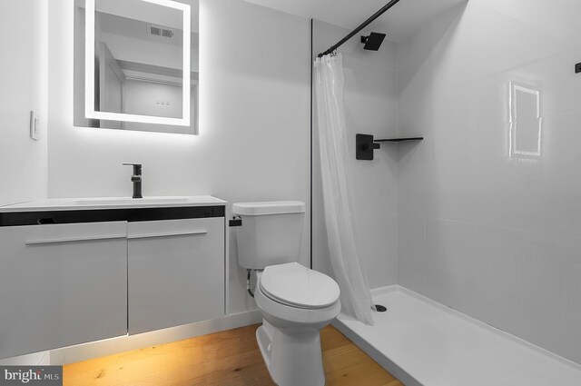 3306 E Lombard St, Baltimore, MD 21224 - bathroom with vanity, curtained shower, and wood finished floors