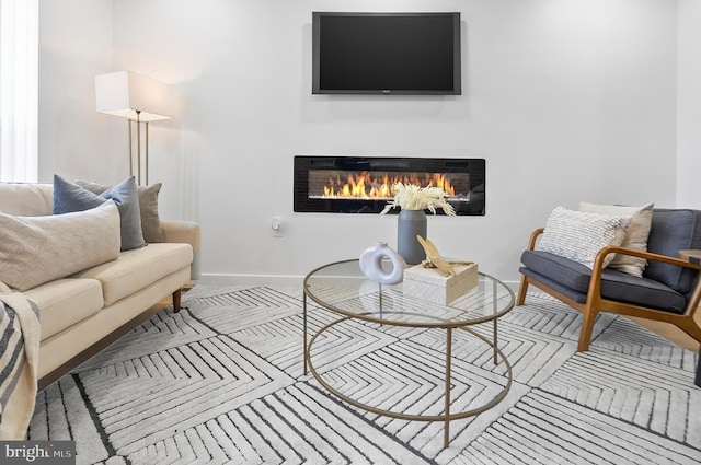 3306 E Lombard St, Baltimore, MD 21224 - living room featuring a glass covered fireplace and baseboards