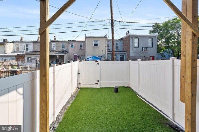 3306 E Lombard St, Baltimore, MD 21224 - fenced backyard featuring a gate and a residential view