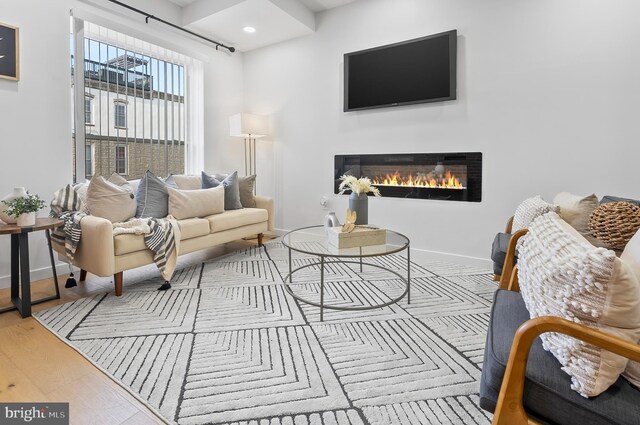 3306 E Lombard St, Baltimore, MD 21224 - living area with a glass covered fireplace, wood finished floors, and recessed lighting