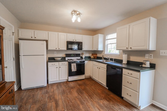 365 Charles Cir, Hellam, PA 17406 - kitchen with black appliances, dark countertops, dark wood-style flooring, and white cabinets