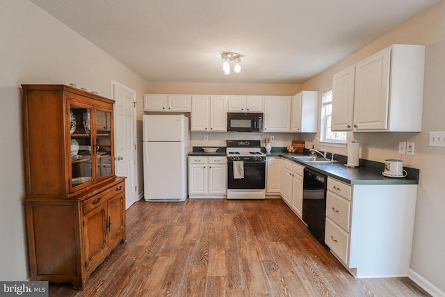 365 Charles Cir, Hellam, PA 17406 - kitchen with black appliances, dark countertops, dark wood-type flooring, and white cabinets