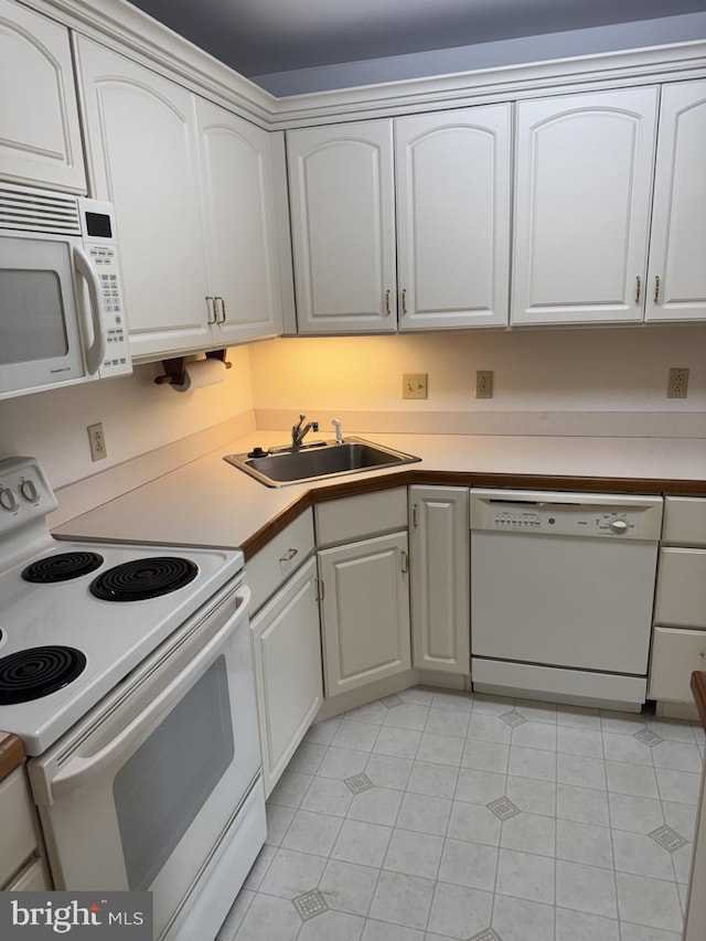 1103 S Schumaker Dr Unit C-300, Salisbury, MD 21804 - kitchen featuring white appliances, light tile patterned floors, white cabinets, and light countertops
