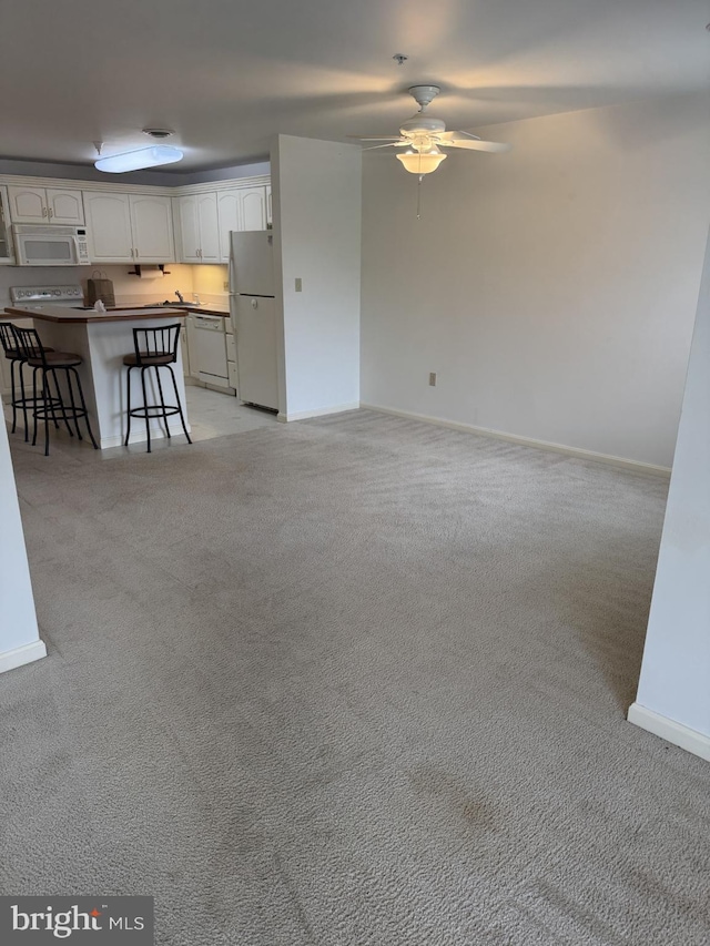 1103 S Schumaker Dr Unit C-300, Salisbury, MD 21804 - unfurnished living room featuring light colored carpet and a ceiling fan