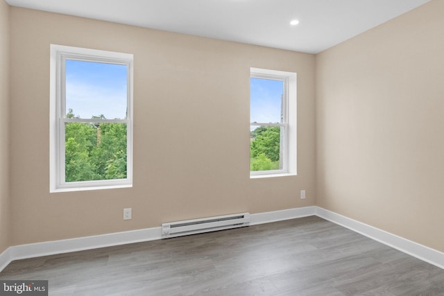 2839 N 9th St, Philadelphia, PA 19133 - empty room with a baseboard heating unit, wood finished floors, and recessed lighting