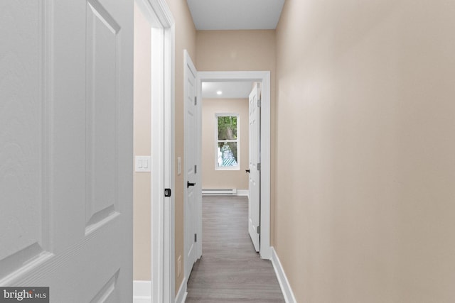 2839 N 9th St, Philadelphia, PA 19133 - hallway featuring a baseboard heating unit and wood finished floors