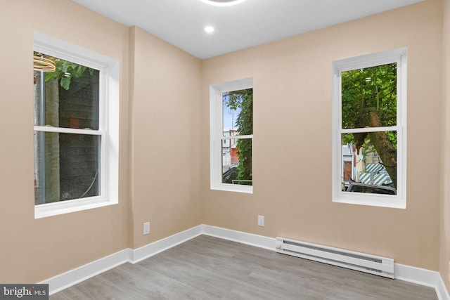 2839 N 9th St, Philadelphia, PA 19133 - unfurnished room with a baseboard heating unit and wood finished floors