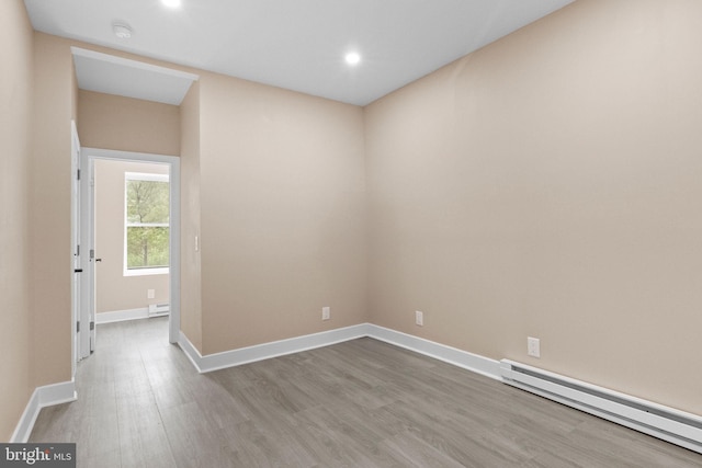 2839 N 9th St, Philadelphia, PA 19133 - spare room featuring a baseboard heating unit, a smoke detector, wood finished floors, and recessed lighting