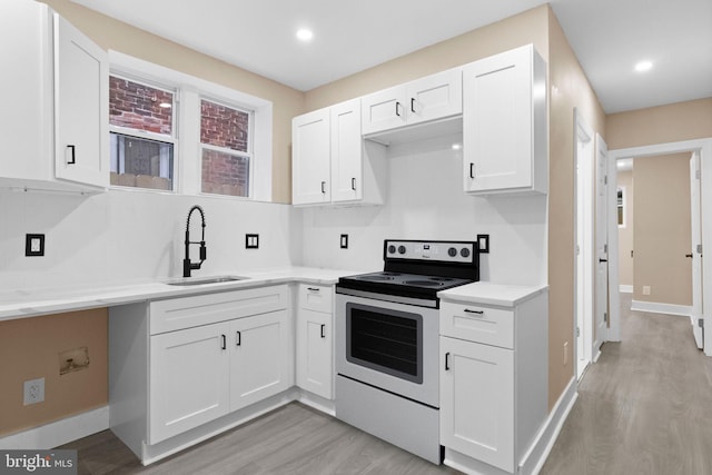 2839 N 9th St, Philadelphia, PA 19133 - kitchen with electric stove, white cabinetry, light wood-style flooring, light countertops, and recessed lighting