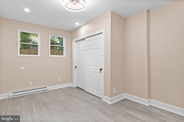 2839 N 9th St, Philadelphia, PA 19133 - unfurnished bedroom with a baseboard heating unit, wood finished floors, a closet, and recessed lighting
