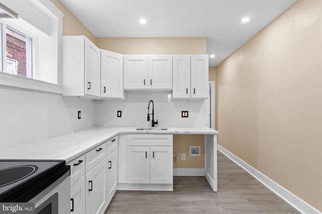 2839 N 9th St, Philadelphia, PA 19133 - kitchen featuring decorative backsplash, light wood-style floors, white cabinets, and recessed lighting