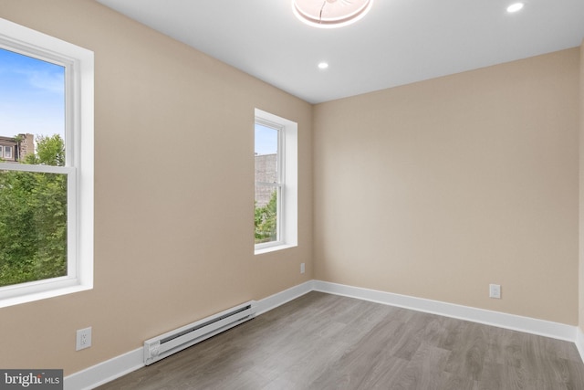 2839 N 9th St, Philadelphia, PA 19133 - spare room with a baseboard heating unit, wood finished floors, and recessed lighting