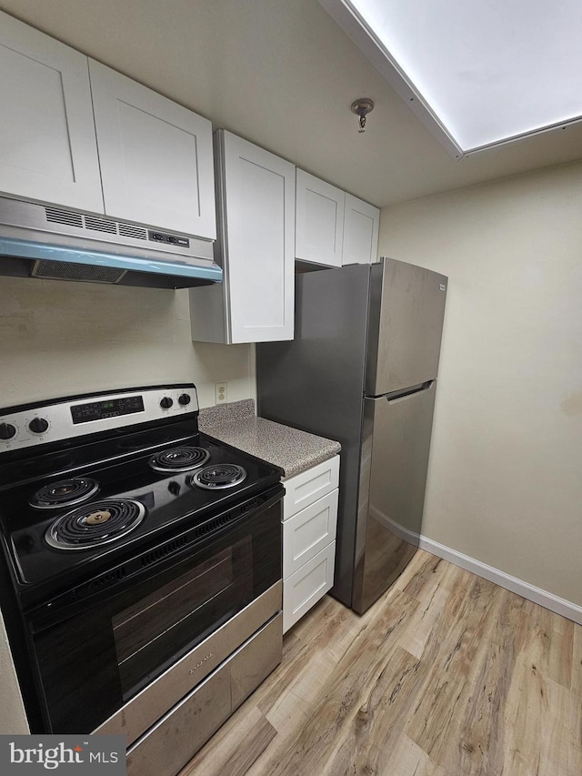 655 Absecon Blvd Unit 1002, Atlantic City, NJ 08401 - kitchen with stainless steel appliances, under cabinet range hood, light wood-style flooring, and white cabinetry