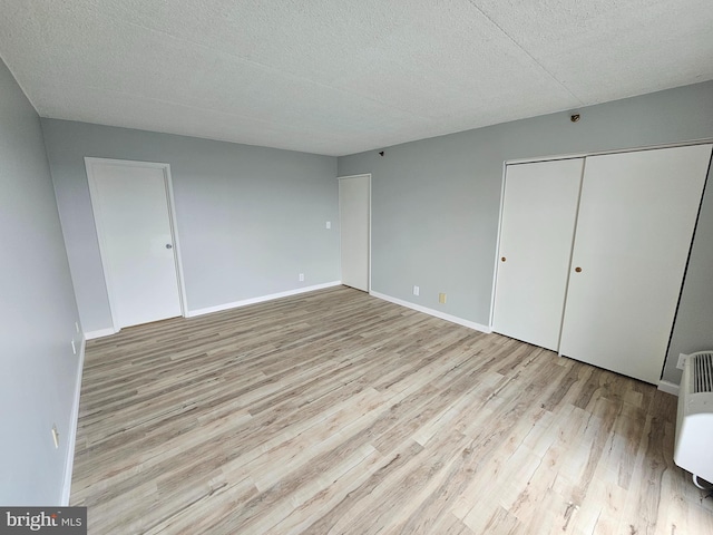 655 Absecon Blvd Unit 1002, Atlantic City, NJ 08401 - unfurnished bedroom with wood finished floors, a textured ceiling, and a closet