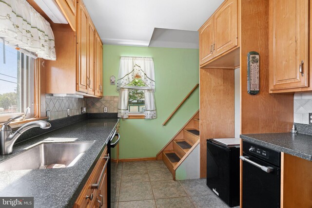 942 Paul St, Gloucester City, NJ 08030 - kitchen featuring dark countertops, healthy amount of natural light, tasteful backsplash, and dishwasher